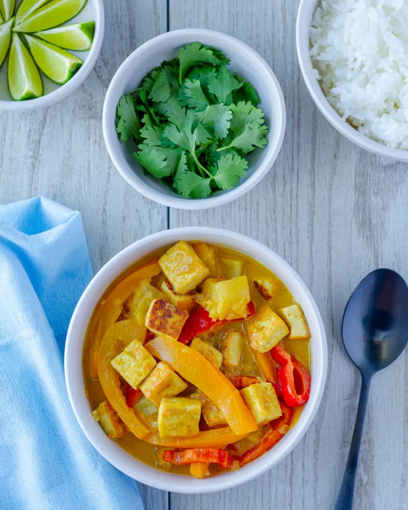 Pineapple tofu curry being served with cilantro as a garnish. 