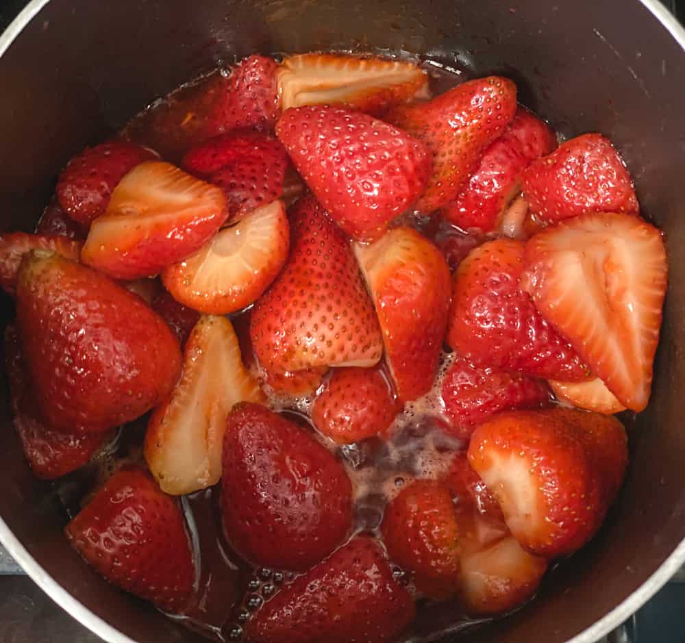 strawberries simmering in a small pot