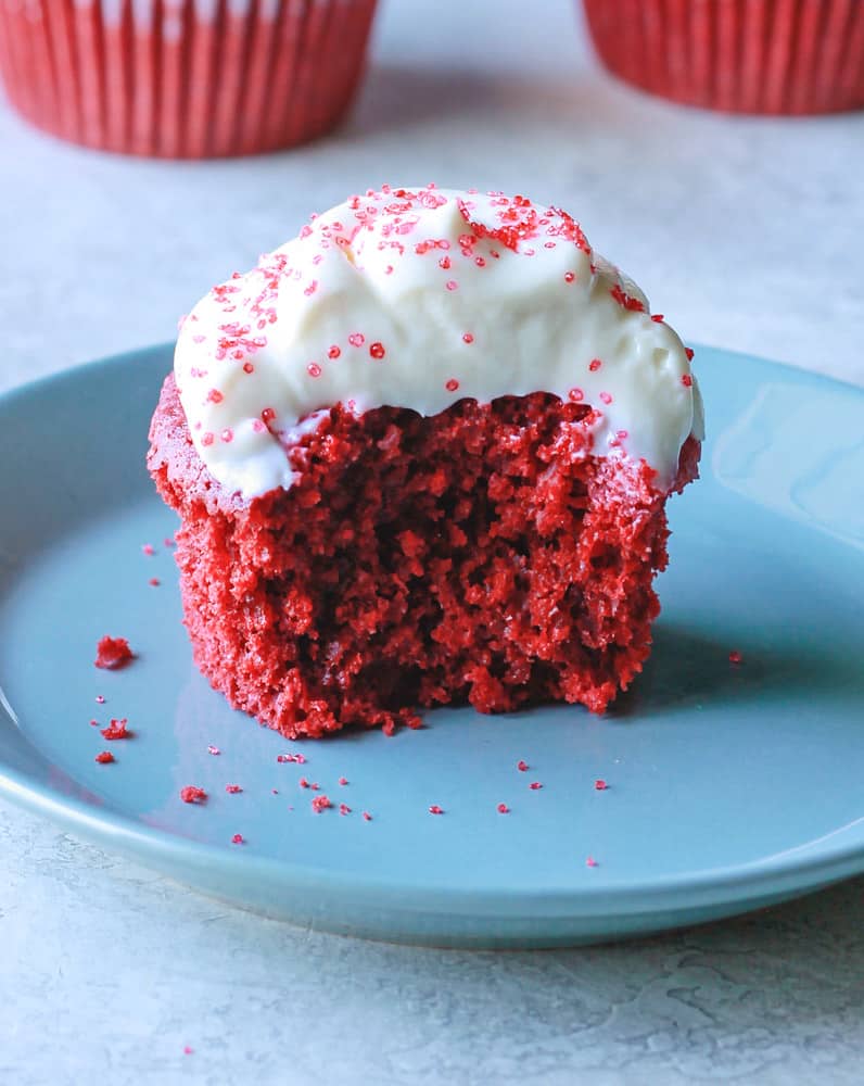 a healthy red velvet cupcake with a bite taken out of it