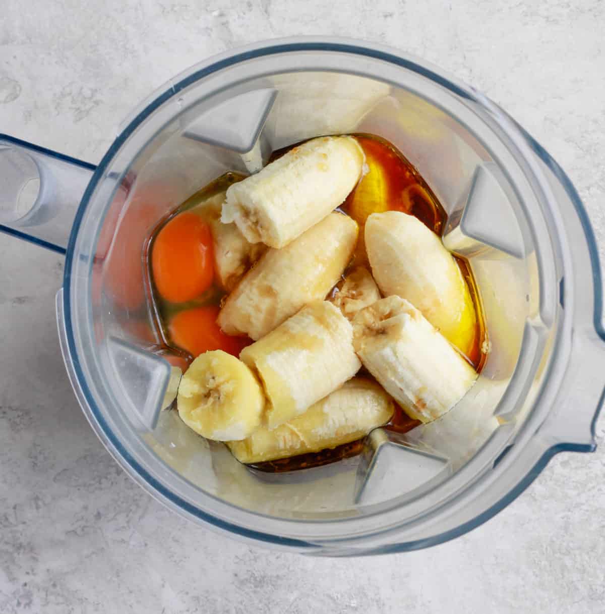 a high-speed blender with bananas in it