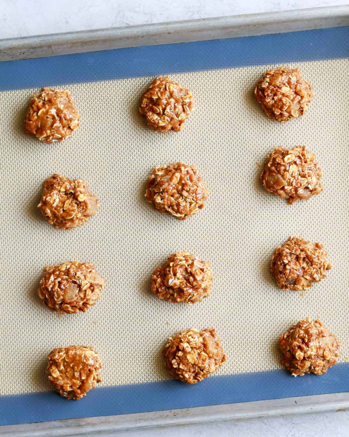 oatmeal ginger cookie dough balls on a baking sheet