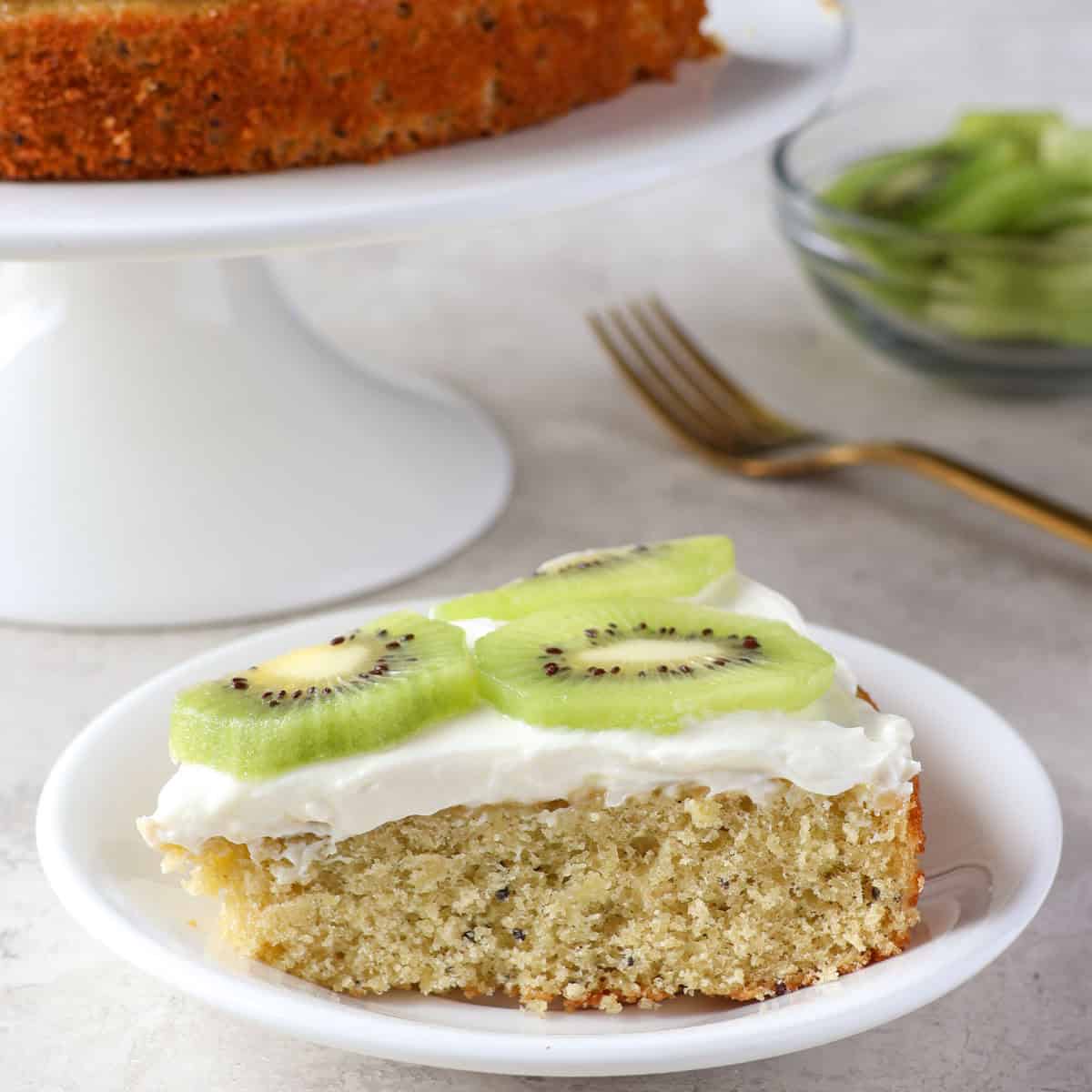a slice of kiwi cake on a white plate