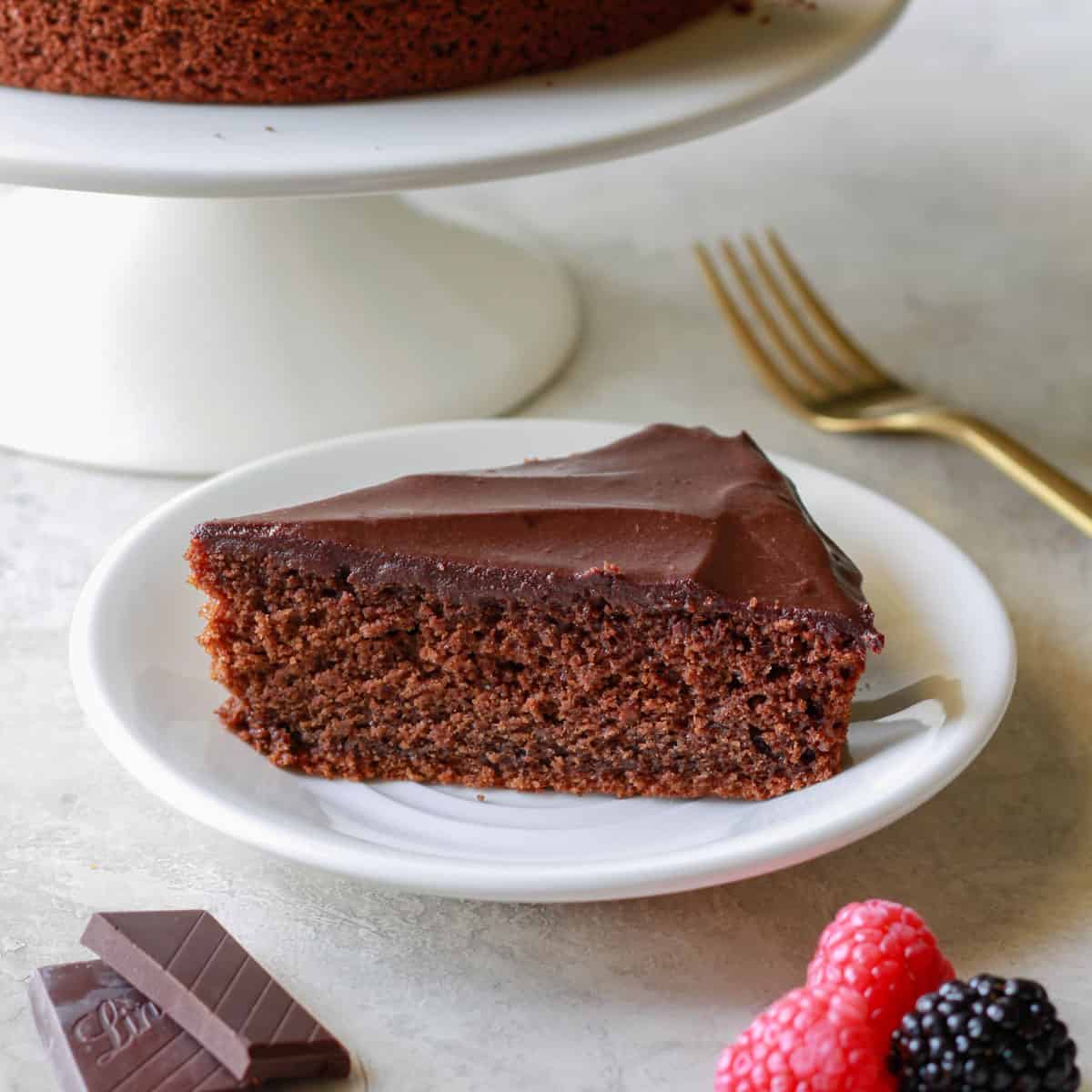 Rich chocolate cake made with oat flour on a white plate