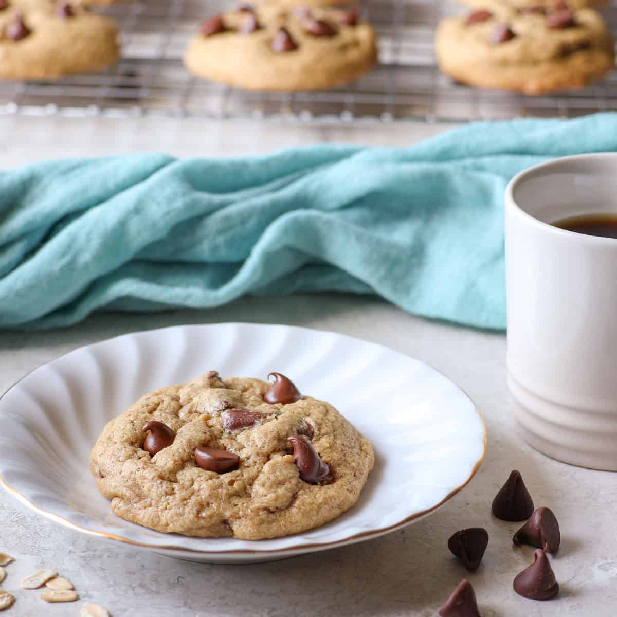 Soft and chewy oat flour chocolate chip cookie on a white plate