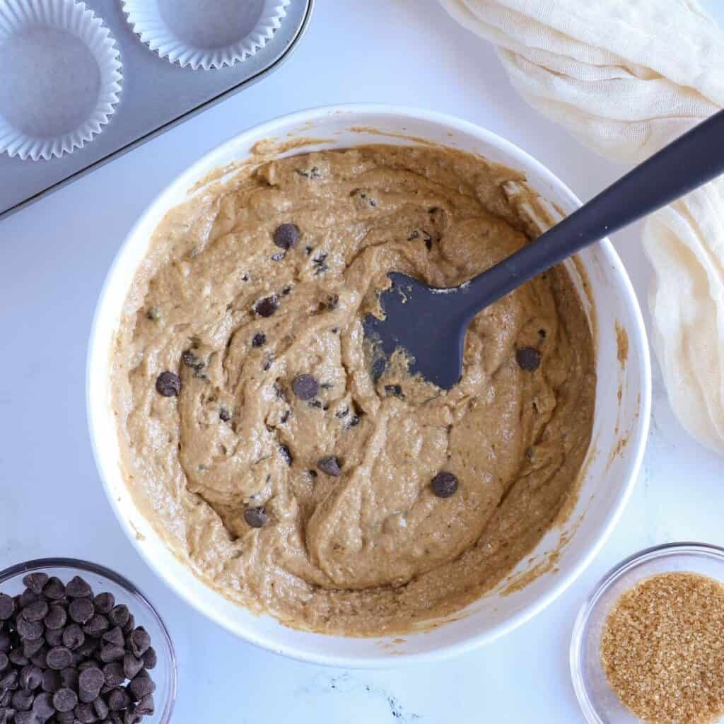 oat flour muffin batter in a white bowl with a spatula