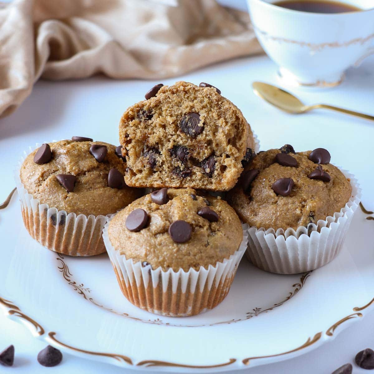 chocolate chip oat flour muffins with one cut in half