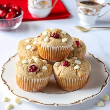 oat flour muffins with white chocolate and cranberry on a white plate