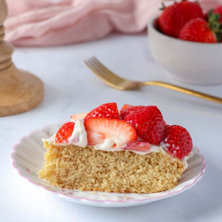 Healthy strawberry shortcake made with oat flour and topped with maple yogurt cream and fresh strawberries