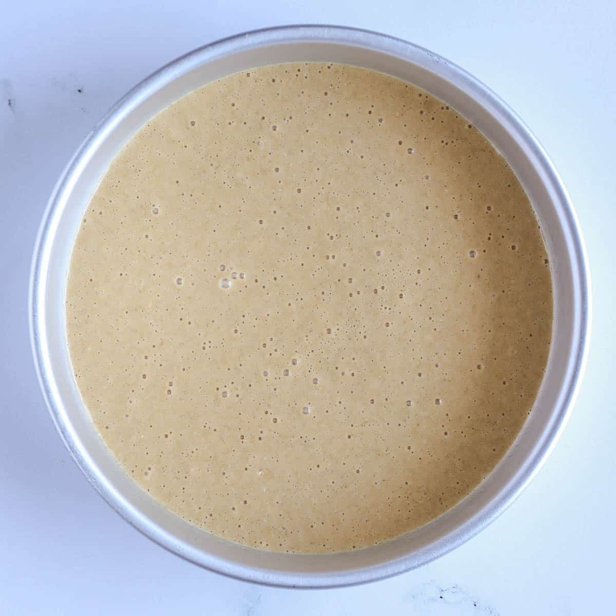 protein cake batter spread in baking pan