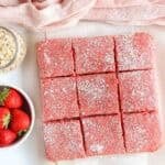strawberry protein bars cut into squares and dusted with powdered sugar.