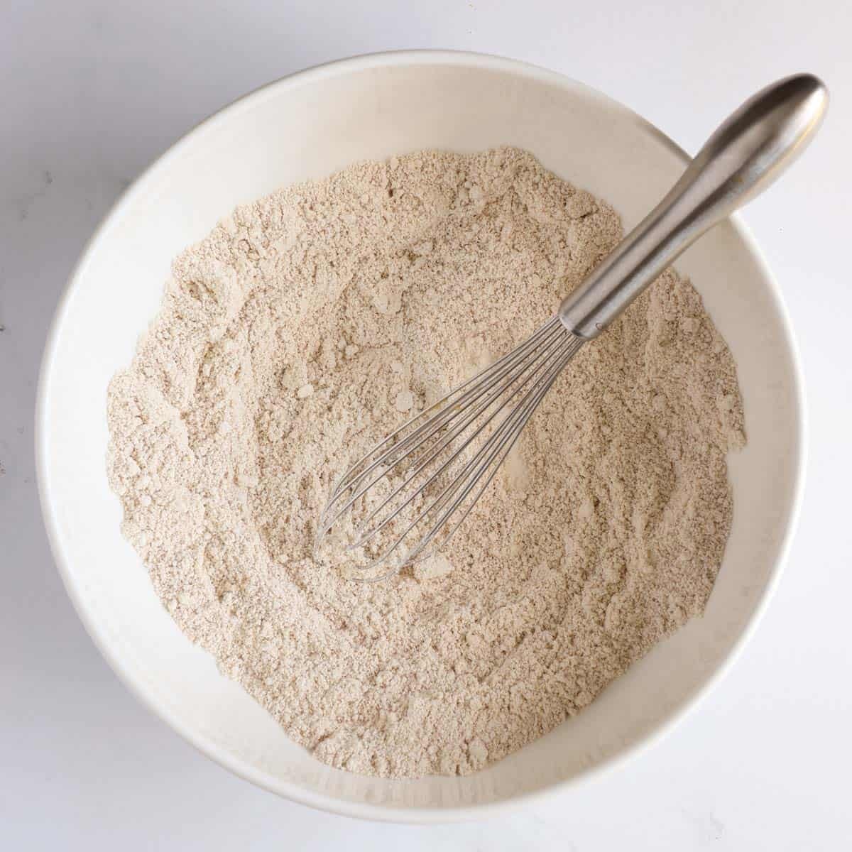 Whisking together the dry ingredients for peanut butter oat dog muffins.
